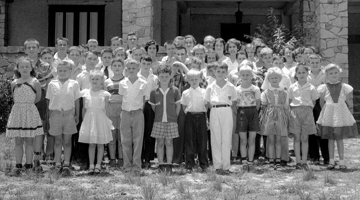 Historical photo of students standing outside of a school.